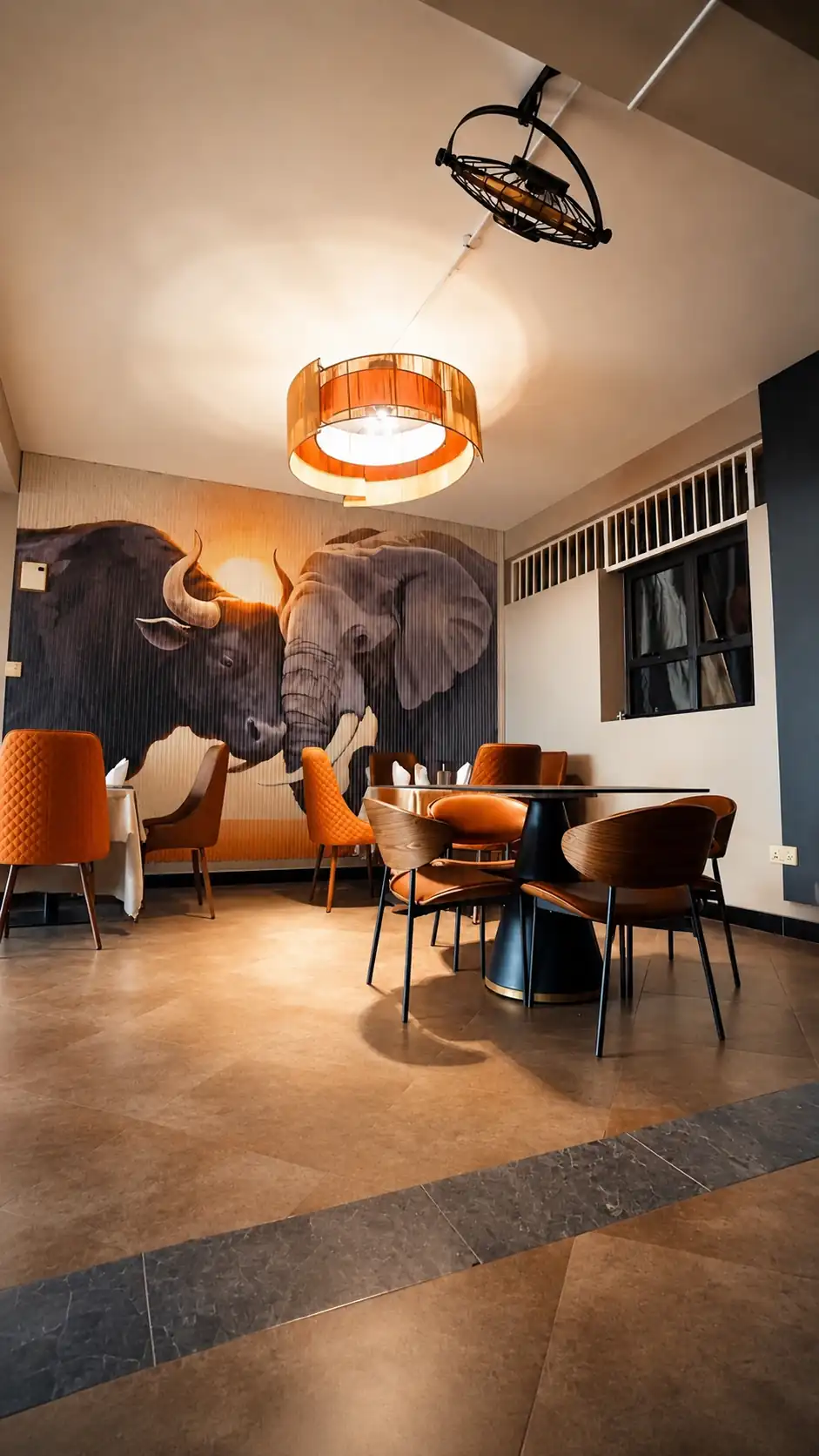 Hotel restaurant dining room with decorative chandelier in Kiboga