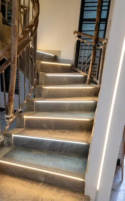 Luxury staircase lighting featuring recessed LED step lights and custom architectural profile lighting in Kampala, Uganda by Dynawatt Engineering Services